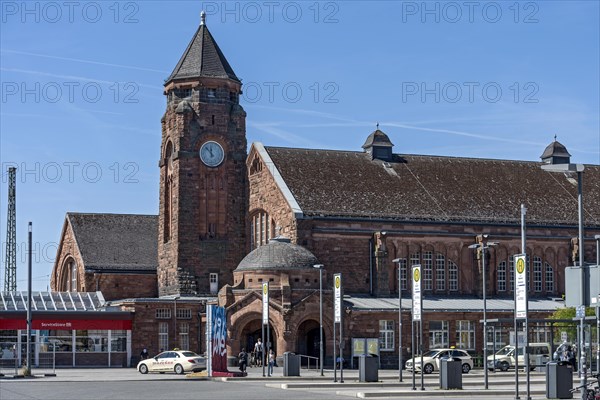 Historic Wilhelmine railway station, clock tower, reception building with bus station, neo-Romanesque and Art Nouveau, red sandstone, cultural monument, listed building, Giessen, Giessen, Hesse, Germany, Europe
