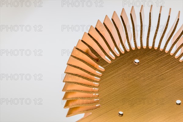 Closeup of mounting surface of round copper heat sink on white background