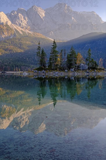 Mountain lake in front of steep mountains, reflection, evening light, autumn, Eibsee lake, view of Zugspitze, Bavaria, Germany, Europe