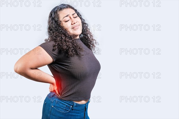 Woman with back pain on isolated background. lumbar problems concept. Girl with spine problems isolated. A sore girl with back pain
