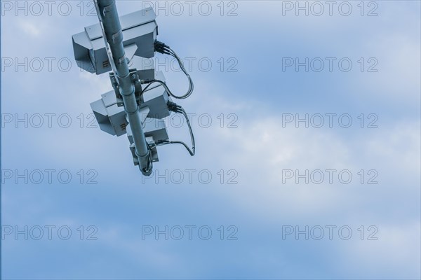 Speed radar cameras mounted on metal pole against blue sky with puffy white clouds in Daejeon, South Korea, Asia