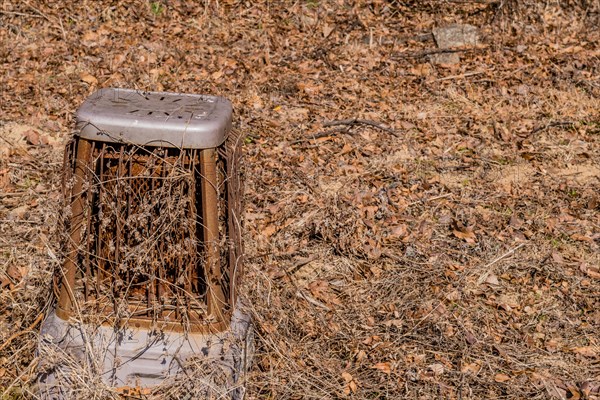 Old rusted metal space heater sitting in open field on dry winter morning in Boeun, South Korea, Asia