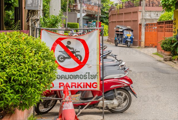 No parking sign displayed on a busy street with motorbikes in the background, in Chiang Mai, Thailand, Asia