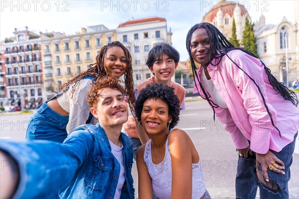 Personal perspective of a multi-ethnic group of friends talking a selfie in the city