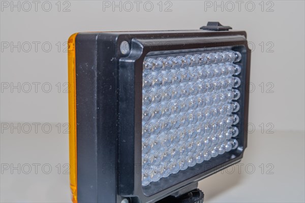 Closeup of LED continuous photographic light on white background. Selective focus on center rows of lights
