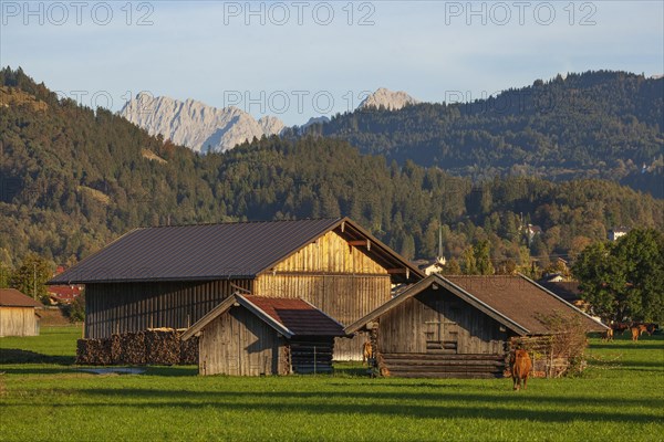 Hay barn with meadow and Karwendel mountains in the evening light, Garmisch-Partenkirchen, Werdenfelser Land, Upper Bavaria, Bavaria, Germany, Europe