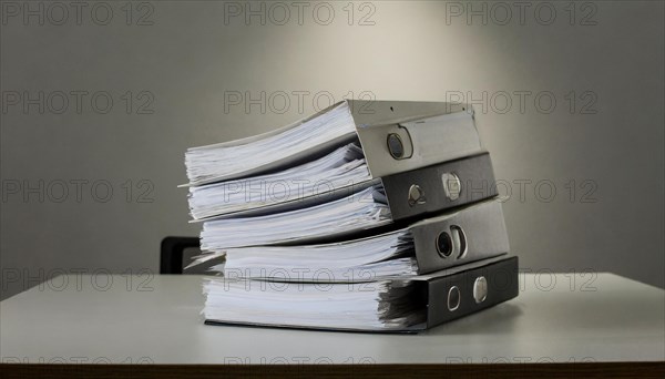 Stacks of black folders with many pages on a desk, symbolism bureaucracy, AI generated, AI generated