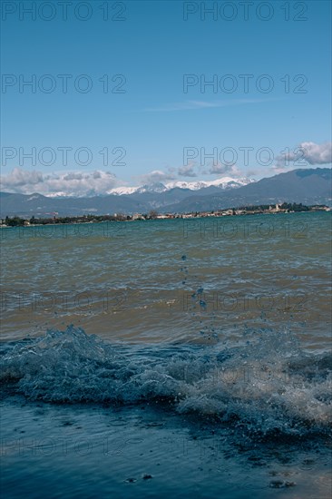 Splashing waves hitting the shore of Lake Garda, Sirmione, Lake Garda, Italy, Europe