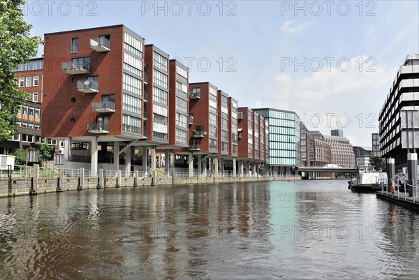 New red brick buildings are reflected in the water surface of a city canal, Hamburg, Hanseatic City of Hamburg, Germany, Europe