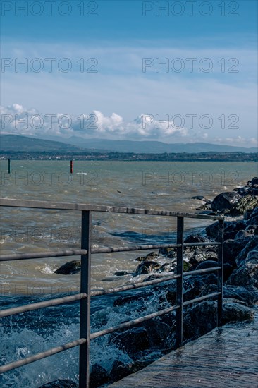 Splashing waves hitting rocks on the shore of Lake Garda, Sirmione, Lake Garda, Italy, Europe