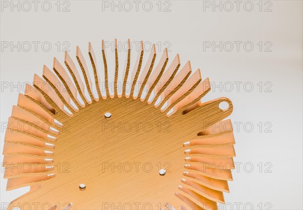 Closeup of mounting surface of round copper heat sink on white background