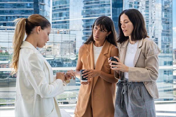 A female boss is telling two of her employees that the break has ended