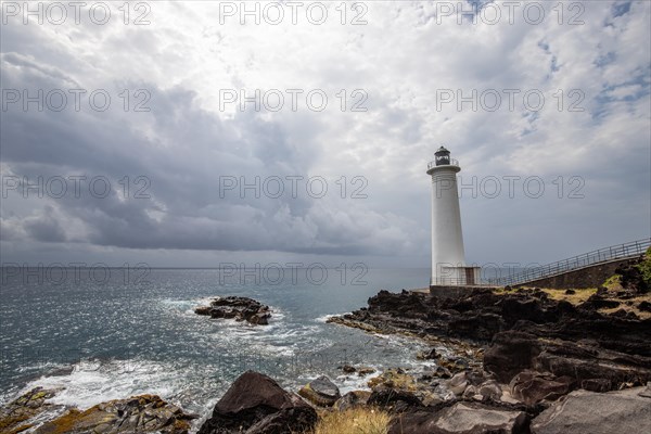 Le Phare du Vieux-Fort, white lighthouse on a cliff. Dramatic clouds with a view of the sea. Pure Caribbean on Guadeloupe, French Antilles, France, Europe