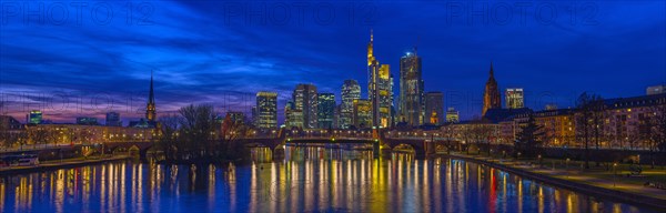 The Frankfurt skyline with office tower blocks behind the Main at blue hour after sunset, on the left the Dreikoenigskirche, on the right the Kaiserdom, Frankfurt am Main, Hesse, Germany, Europe