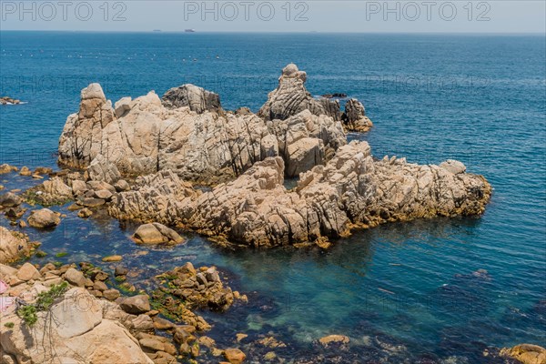 A view of a rugged coastline with clear ocean waters and rocky outcrops, in Ulsan, South Korea, Asia
