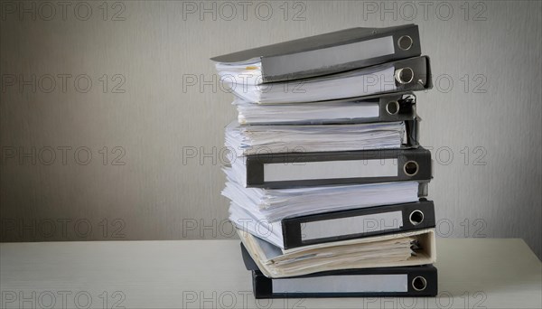 A high pile of files on a table symbolises a large workload, symbolism bureaucracy, AI generated, AI generated