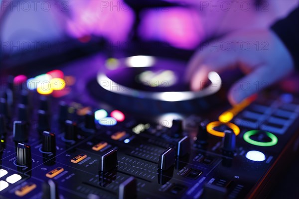 Hand of a DJ on a mixing desk, also called DJ controller or DJ console, at a party, Cologne, North Rhine-Westphalia, Germany, Europe