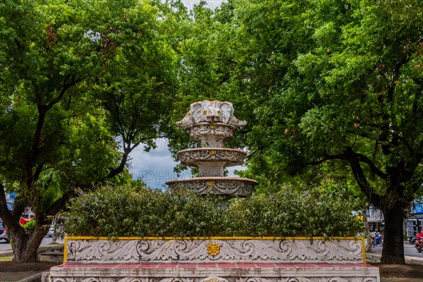 Ornate fountain in a park setting surrounded by lush green trees, in Chiang Mai, Thailand, Asia