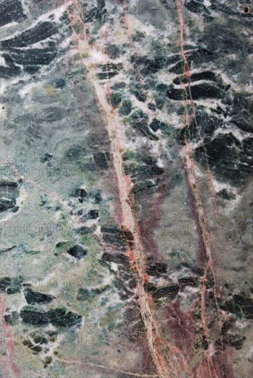 Green marble with distinctive pink veins, showcasing the intricate patterns of a polished stone surface