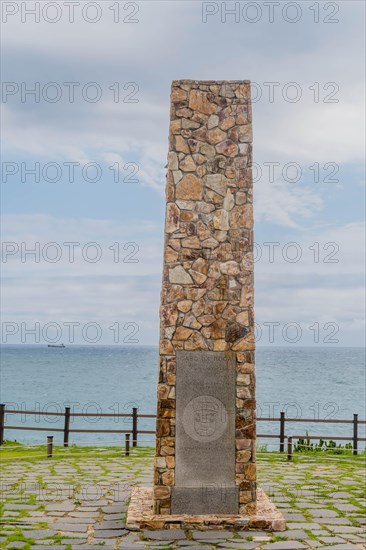 Historical engraved monument made of stones, set against the sky within a fenced area, in Ulsan, South Korea, Asia