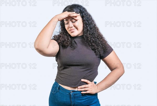 Tired and exhausted girl holding her forehead. Worried young woman holding his forehead. Exhausted woman with palm on forehead isolated