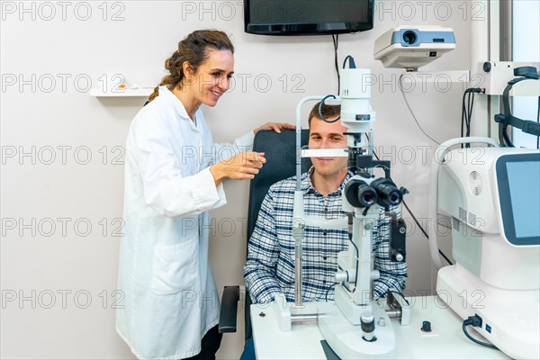 Horizontal photo of a man sitting doing a routine checkup in an ophthalmologist
