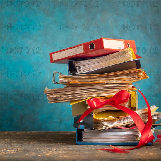 A pile of folders, tied with a red ribbon, similar to a gift, symbolising bureaucracy, AI generated, AI generated