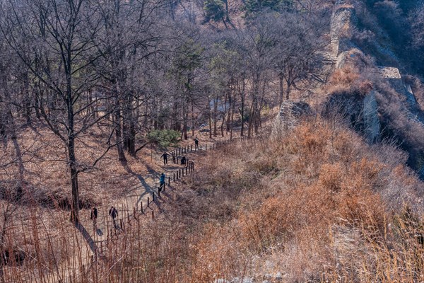 Unidentified tourists walking dirt hiking trail at Samnyeon Mountain Fortress in Boeun, South Korea, Asia