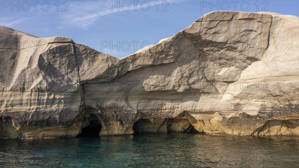 Caves in the white rocks on the coast near Sarakinikoer, Milos, Cyclades, Greece, Europe