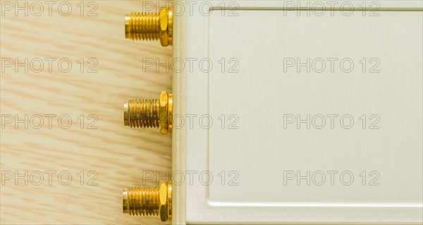 Close-up of gold connectors for antenna ports on beige casing, in South Korea