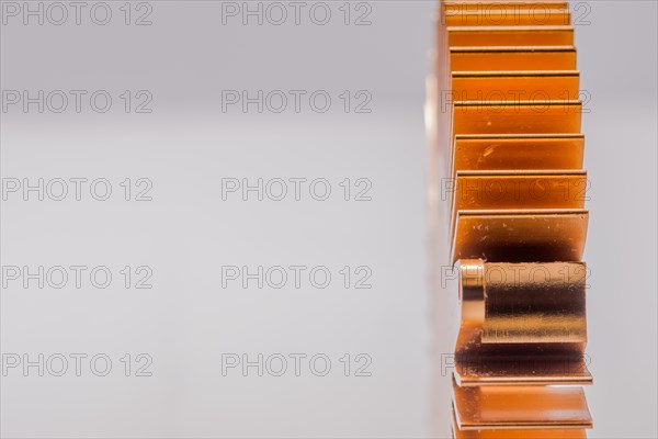 Closeup of copper computer heat sink fins on white background