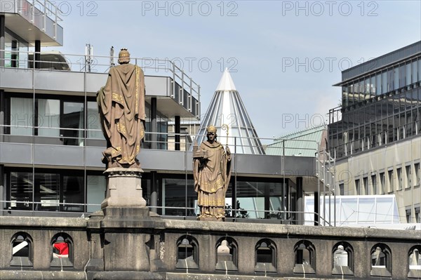 Two statues on a building look over the urban space, under a clear sky, Hamburg, Hanseatic City of Hamburg, Germany, Europe