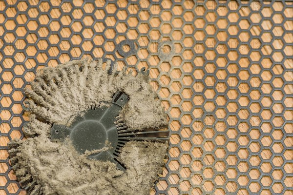 Central processing unit (CPU) with remnants of dried thermal paste on a patterned background, in South Korea