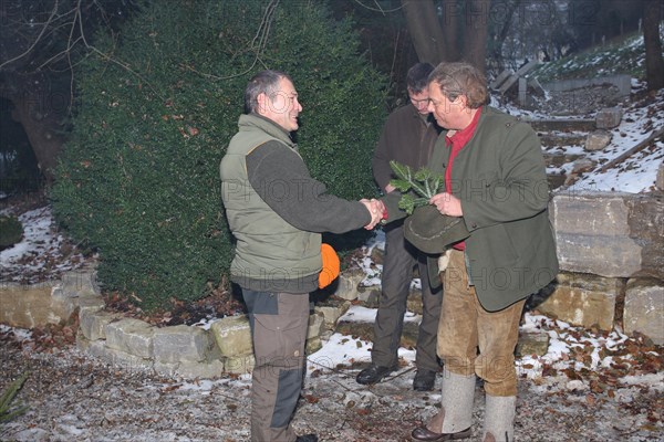Wild boar (Sus scrofa) end of the hunt, huntsman presents a marksman with the so-called Schuetzenbruch, tradition, Allgaeu, Bavaria, Germany, Europe