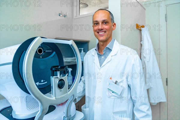Portrait of an ophthalmologist in an innovative clinic standing next to a laser machine to treat glaucoma