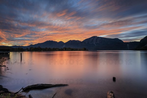 Dawn over a lake in front of mountains, long exposure, Lake Kochel, view of Rabenkopf and Jochberg, Kochler mountains, Alpine foothills, Bavaria, Germany, Europe