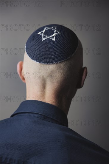 Jewish man wearing a kippa with a Star of David on his head, back view, studio shot, Germany, Europe