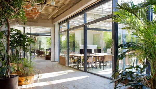 Airy office with a view of the greenery thanks to floor-to-ceiling windows and natural wood furnishings, Symbol office, AI generated, AI generated