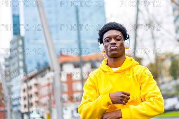 Portrait with copy space of a cool stylish african man dancing confident in the city