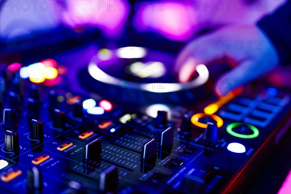 Hand of a DJ on a mixing desk, also called DJ controller or DJ console, at a party, Cologne, North Rhine-Westphalia, Germany, Europe