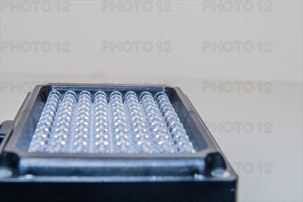 Closeup of LED continuous photographic light on white background. Selective focus on rear row of light