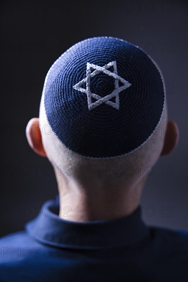 Jewish man wearing a kippa with a Star of David on his head, back view, studio shot, Germany, Europe