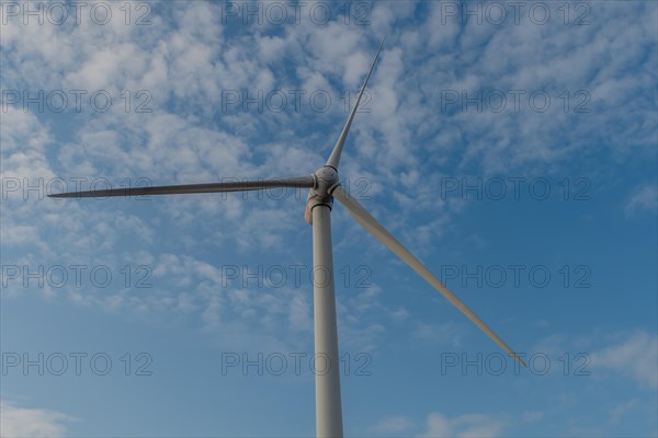 Low angle view of electrical generating windmill against cloudy sky in Buan, South Korea, Asia