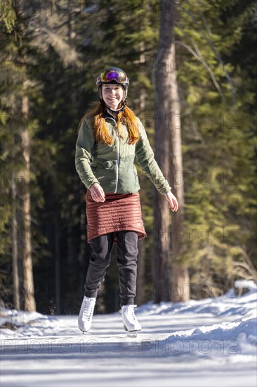 Ice skater, ice path through the forest, Sur En, Sent near Scuol, Engadin, Switzerland, Europe