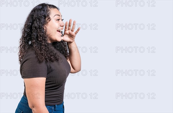 Happy girl announcing something isolated. Beautiful woman screaming and announcing an advertising isolated