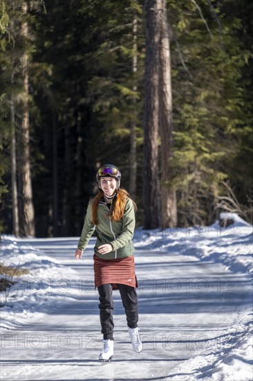 Ice skater, ice path through the forest, Sur En, Sent near Scuol, Engadin, Switzerland, Europe