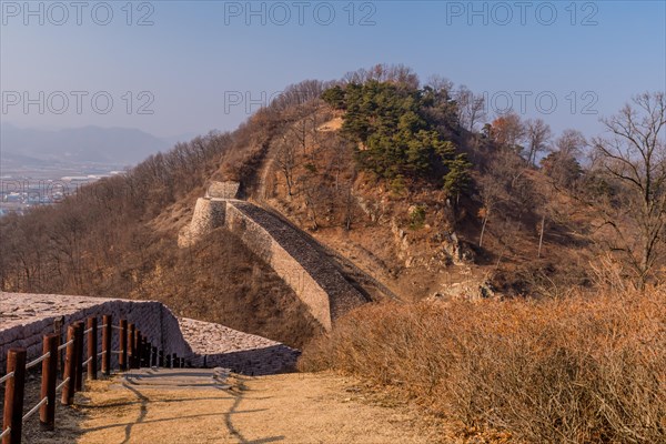 Landscape of mountaintop with sections of fortress wall made of flat stones located in Boeun, South Korea, Asia