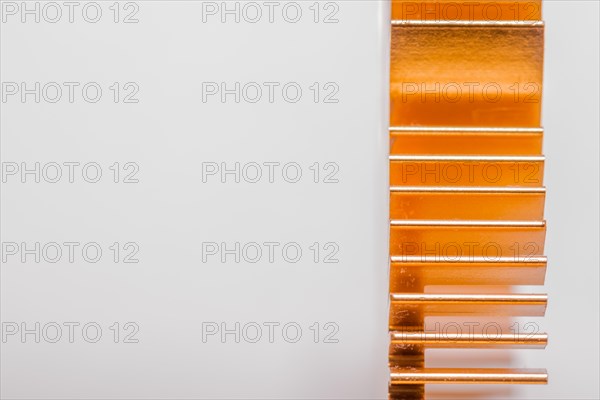 Closeup of copper computer heat sink fins on white background