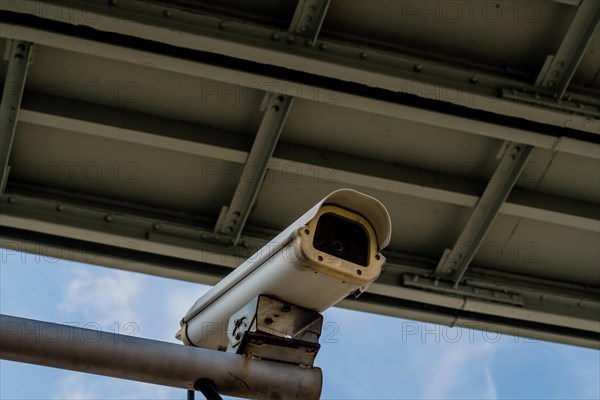 Security camera mounted on a metal pole under a metal bridge in Daejeon, South Korea, Asia