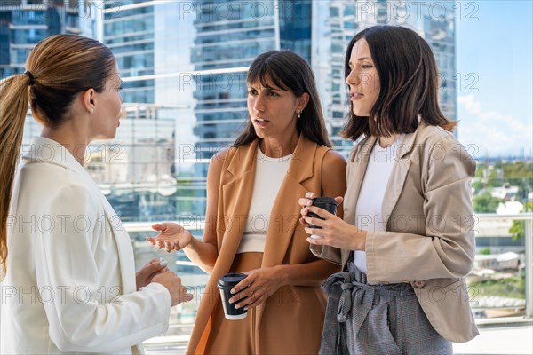 The female boss is informing her two employees that they need to focus on work rather than engaging in gossip. One of them does not like her comment